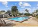 Community pool with lounge chairs and tropical landscaping, offering a resort-style amenity at 2539 Antilles Dr, Winter Park, FL 32792
