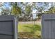 View of the community tennis courts through a gate, highlighting recreational amenities at 2539 Antilles Dr, Winter Park, FL 32792