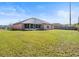 Wide angle of backyard with grass lawn and perimeter fence at 2540 Courtland Blvd, Deltona, FL 32738
