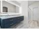 Bathroom featuring a modern vanity with dual sinks, updated lighting, and a glass-enclosed shower at 2540 Courtland Blvd, Deltona, FL 32738