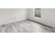 Empty bedroom with wood-look flooring and a window at 2540 Courtland Blvd, Deltona, FL 32738