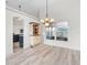 Dining room features wood floors, modern chandelier, and views to the kitchen at 2540 Courtland Blvd, Deltona, FL 32738