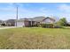 Inviting single-Gathering home with a lush green lawn, a two-car garage, and lovely landscaping at 2540 Courtland Blvd, Deltona, FL 32738