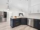 Modern kitchen features white countertops, stainless steel appliances, and black cabinets at 2540 Courtland Blvd, Deltona, FL 32738
