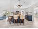 Bright open kitchen featuring wood flooring, modern appliances, island with bar seating and white countertops at 2540 Courtland Blvd, Deltona, FL 32738