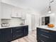 Beautiful kitchen with white upper cabinets and dark blue base cabinets and drawers with stainless steel hardware at 2540 Courtland Blvd, Deltona, FL 32738