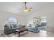 Comfortable living room featuring wood-look flooring, a ceiling fan, and sliding glass doors to the patio at 2540 Courtland Blvd, Deltona, FL 32738
