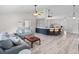 Open-concept living space with stylish decor, white walls, island with seating, and contemporary ceiling fans at 2540 Courtland Blvd, Deltona, FL 32738