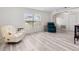 Inviting living area with wood floors, two accent chairs, and natural light from large windows at 2540 Courtland Blvd, Deltona, FL 32738