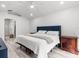 Primary bedroom featuring wood-look flooring, white walls, a ceiling fan, and a tufted blue headboard at 2540 Courtland Blvd, Deltona, FL 32738