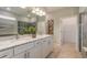 Modern bathroom with dual vanities, stone countertops, and a glass-enclosed shower at 2721 Serenity Meadow Dr, Kissimmee, FL 34744
