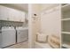 Convenient mud room with coat hooks, storage, and bench with decorative pillows at 2721 Serenity Meadow Dr, Kissimmee, FL 34744