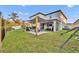 Well-maintained backyard featuring a covered patio, green lawn, and fenced perimeter at 2940 Scarlett Dr, St Cloud, FL 34772