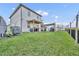 Exterior view of the home with a spacious backyard featuring a patio and grill area at 2940 Scarlett Dr, St Cloud, FL 34772