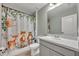 Bathroom featuring a vanity, mirror, and shower with decorative animal-themed shower curtain at 2940 Scarlett Dr, St Cloud, FL 34772