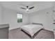 A well-lit bedroom with a window, a ceiling fan, and gray carpet at 2940 Scarlett Dr, St Cloud, FL 34772
