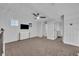 Carpeted bedroom with a ceiling fan, mounted TV, and natural light from the windows at 2940 Scarlett Dr, St Cloud, FL 34772