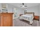 Well lit bedroom with ceiling fan and a natural wood dresser with white walls at 2940 Scarlett Dr, St Cloud, FL 34772