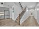 Inviting entryway featuring an impressive staircase and natural wood-look tile flooring at 2940 Scarlett Dr, St Cloud, FL 34772