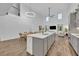 Open-concept living space with a modern kitchen, dining area, and comfortable seating at 2940 Scarlett Dr, St Cloud, FL 34772