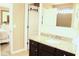 Bright bathroom showcasing granite countertops, dark cabinetry, and ceramic tile floors at 3039 Boating Blvd. Blvd, Kissimmee, FL 34746