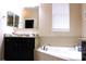 Bright bathroom with a soaking tub and granite countertop vanity at 3039 Boating Blvd. Blvd, Kissimmee, FL 34746