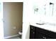 Well-lit bathroom features dark wood cabinetry and granite countertop at 3039 Boating Blvd. Blvd, Kissimmee, FL 34746