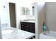 Bright bathroom featuring dual sinks, granite countertops, and a bathtub with tiled walls at 3039 Boating Blvd. Blvd, Kissimmee, FL 34746
