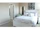 Bright bedroom with a white bed, a nightstand with lamp, and calming artwork at 3039 Boating Blvd. Blvd, Kissimmee, FL 34746