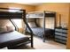Bedroom with bunk beds featuring sturdy metal frames, complemented by soft gray bedding and neutral walls at 3039 Boating Blvd. Blvd, Kissimmee, FL 34746