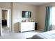 Cozy bedroom with mounted TV and white dresser; a comfortable, minimalist space at 3039 Boating Blvd. Blvd, Kissimmee, FL 34746