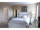 Bright bedroom with a white bed, a nightstand with lamp, and calming artwork at 3039 Boating Blvd. Blvd, Kissimmee, FL 34746