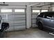 Two-car garage with two overhead doors and vehicles parked inside at 3039 Boating Blvd. Blvd, Kissimmee, FL 34746