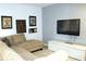Comfortable living room area with a large couch, entertainment center, and decor at 3039 Boating Blvd. Blvd, Kissimmee, FL 34746