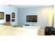 Living room featuring a large sectional sofa and a wall-mounted television at 3039 Boating Blvd. Blvd, Kissimmee, FL 34746