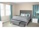 Luxurious main bedroom featuring tufted headboard, stylish bench, and bright, sunlit windows at 3039 Boating Blvd. Blvd, Kissimmee, FL 34746