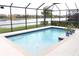Sparkling pool enclosed by a screen with a scenic lake backdrop at 3039 Boating Blvd. Blvd, Kissimmee, FL 34746