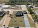 Aerial view of a single Gathering home with a detached garage, driveway, and manicured landscaping at 31905 Larkspur Ave, Eustis, FL 32736