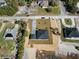 Aerial view of a home featuring a paved driveway, detached garage, and landscaping on a spacious lot at 31905 Larkspur Ave, Eustis, FL 32736