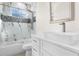 Bright bathroom featuring a marble and mosaic tile shower, white vanity, and modern fixtures at 31905 Larkspur Ave, Eustis, FL 32736