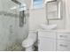 Bathroom featuring a modern glass shower with rainfall showerhead, stylish mosaic tile accents, and sleek vanity at 31905 Larkspur Ave, Eustis, FL 32736