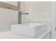 Modern bathroom features a sleek, rectangular sink with a chrome faucet and light-colored marble countertop at 31905 Larkspur Ave, Eustis, FL 32736
