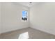 Bright bedroom with neutral walls, light wood-look floors, and a window offering natural light and outdoor views at 31905 Larkspur Ave, Eustis, FL 32736