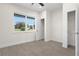 Bright bedroom featuring a closet, window overlooking the backyard, and wood-look tile flooring at 31905 Larkspur Ave, Eustis, FL 32736