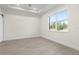 Bright bedroom featuring wood tile floors, large window, and a ceiling fan at 31905 Larkspur Ave, Eustis, FL 32736