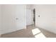 Hallway featuring wood-look tile flooring, white doors, and trim, creating a clean and modern aesthetic at 31905 Larkspur Ave, Eustis, FL 32736