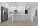 Modern kitchen featuring a gray island with white countertops and stainless-steel appliances at 31905 Larkspur Ave, Eustis, FL 32736