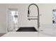Close-up of kitchen sink with stylish faucet, with a view into the attached bathroom at 31905 Larkspur Ave, Eustis, FL 32736
