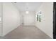 Bright living room featuring wood tile floors, a modern light fixture, and large window at 31905 Larkspur Ave, Eustis, FL 32736