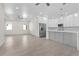 Open-concept living space with kitchen and living room, recessed lighting, tile floor, and large windows at 31905 Larkspur Ave, Eustis, FL 32736